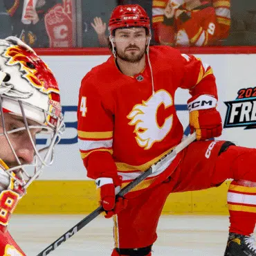 Calgary Flames hockey player in red uniform on ice rink during a game.