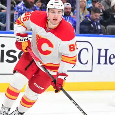 Hockey player in action wearing a Calgary Flames jersey.