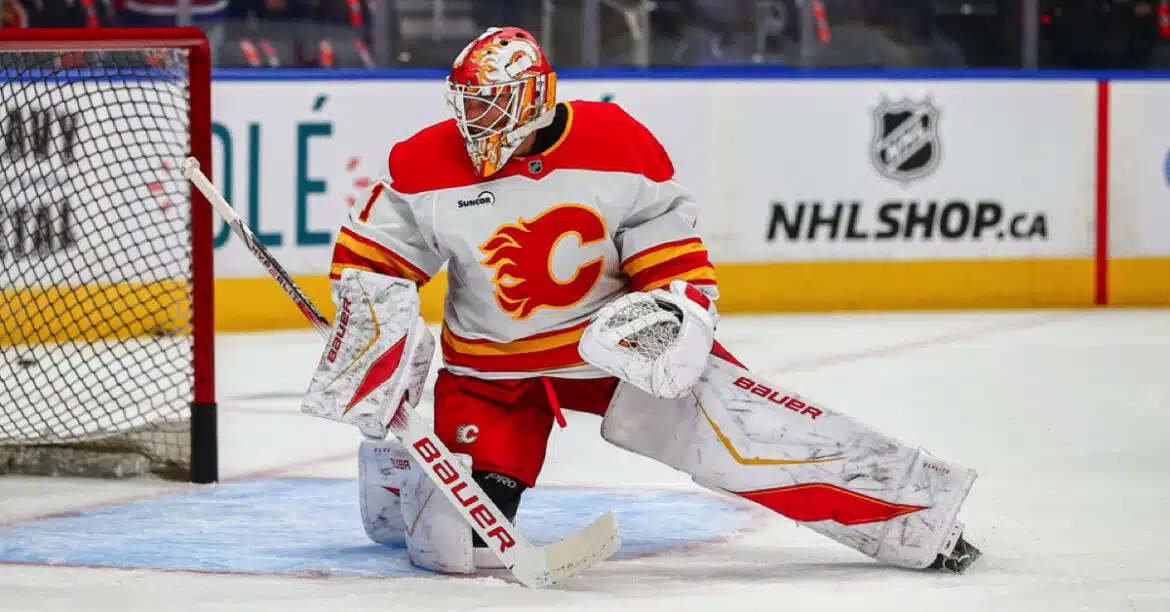 Calgary Flames goalie in action during a hockey game.