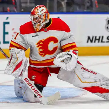 Calgary Flames goalie in action during a hockey game.