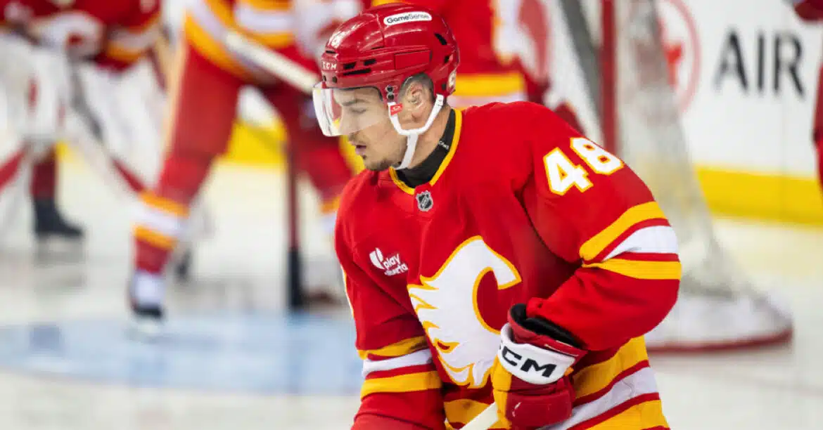 Ice hockey player in red Calgary Flames uniform on the ice.