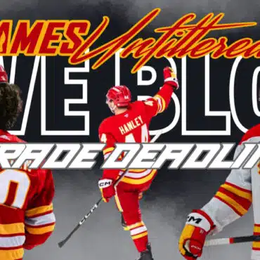 Ice hockey players in red and white uniforms celebrating on the rink.