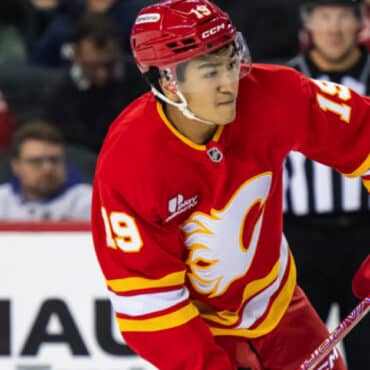 Hockey player in red uniform during game.